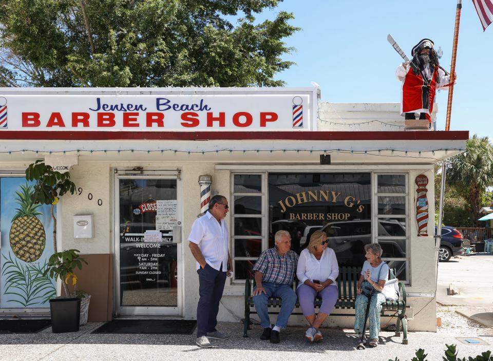 A memorial is held for John Gentile Sr. outside of Johnny G's Barber Shop on Wednesday, April 24, 2024, in downtown Jensen Beach. Gentile, 62, died April 18. He was known for his "quirky' barbershop and worked in the area for 40 years. He was known in the area as the "Mayor of Stuart" and "Papa John."