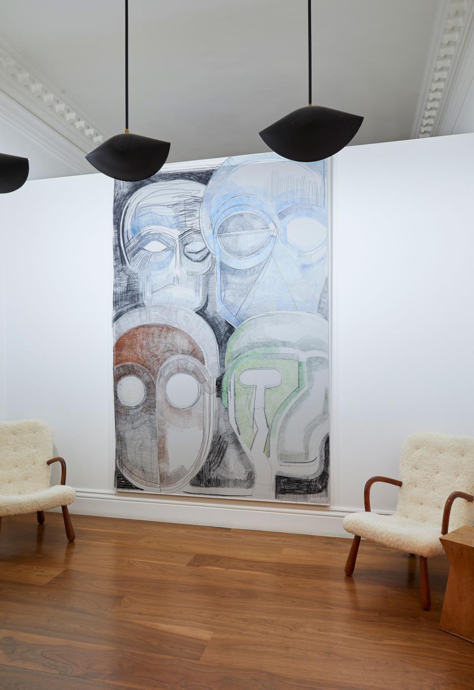 A Thomas Houseago painting of four ghostly figures greets visitors at the entrance. It is nine feet tall and six feet wide, making the vintage Philip Arctander “clam” chairs on either side look almost diminutive.