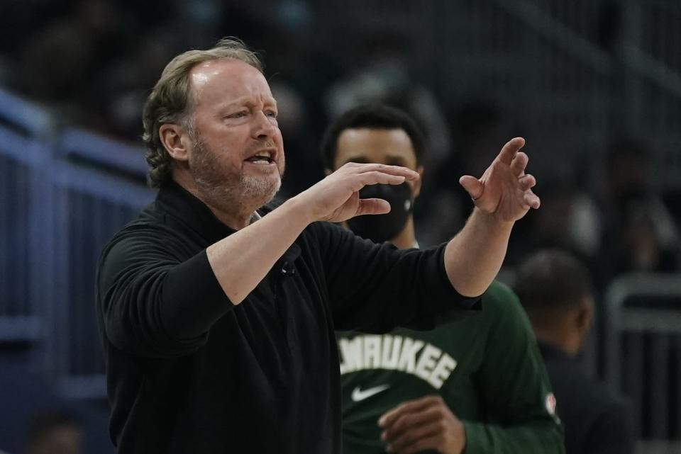 Milwaukee Bucks head coach Mike Budenholzer reacts during the first half of an NBA basketball game against the Golden State Warriors Thursday, Jan. 13, 2022, in Milwaukee. (AP Photo/Morry Gash)