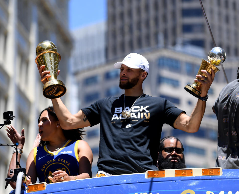 SAN FRANCISCO, CALIFORNIA - JUNE 20: Stephen Curry #30 of the Golden State Warriors and wife Ayesha celebrate with his NBA Finals Most Valuable Player Award during the Victory Parade on June 20, 2022 in San Francisco, California. The Golden State Warriors beat the Boston Celtics 4-2 to win the 2022 NBA Finals. NOTE TO USER: User expressly acknowledges and agrees that, by downloading and or using this photograph, User is consenting to the terms and conditions of the Getty Images License Agreement. (Photo by Michael Urakami/Getty Images)