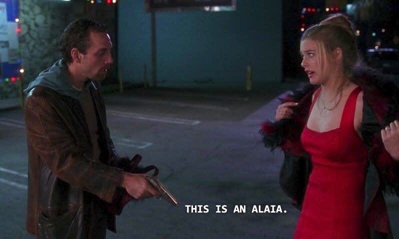 A screenshot of from "Clueless" of the scene where Cher is being mugged while wearing a red dress and says "This is an Alaïa"