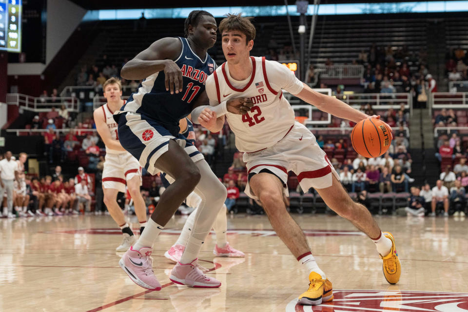 Stanford Cardinal forward Maxime Raynaud (42) drives around Arizona Wildcats center Oumar Ballo (11) during the first half at Maples Pavilion Dec. 31, 2023, in Stanford, California.