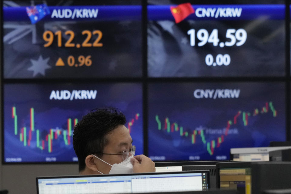 A currency trader watches monitors at the foreign exchange dealing room of the KEB Hana Bank headquarters in Seoul, South Korea, Tuesday, July 26, 2022. Asian stock markets were mostly higher Tuesday as investors braced for another sharp interest rate hike by the Federal Reserve to cool inflation. (AP Photo/Ahn Young-joon)