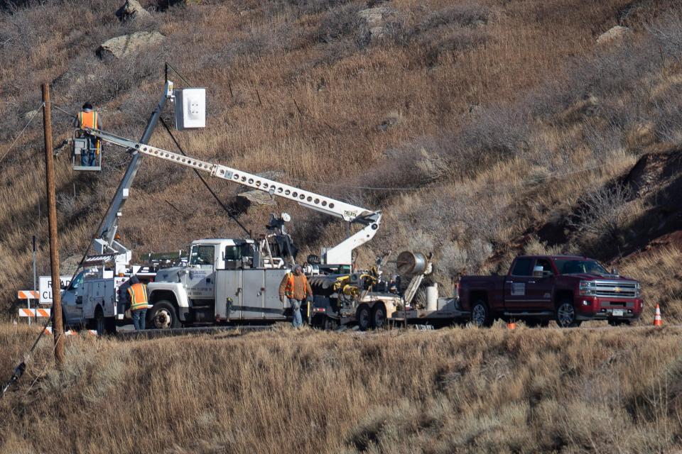 Crews work to fix a down utility line on Thursday, Dec. 16, 2021, along West County Road 38 East near the southeastern edge of Horsetooth Reservoir.