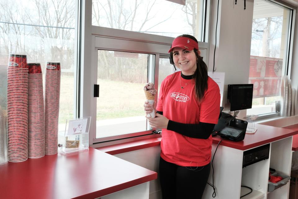 Mia Bleichrodt works the drive-thru window at Bruster's. Her favorite flavor of ice cream is Graham Central Station, a flavor packed full of graham cracker bits and chocolate.