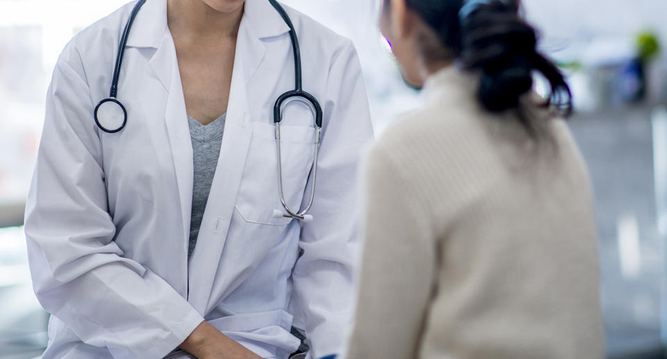 A doctor talking to a patient. 