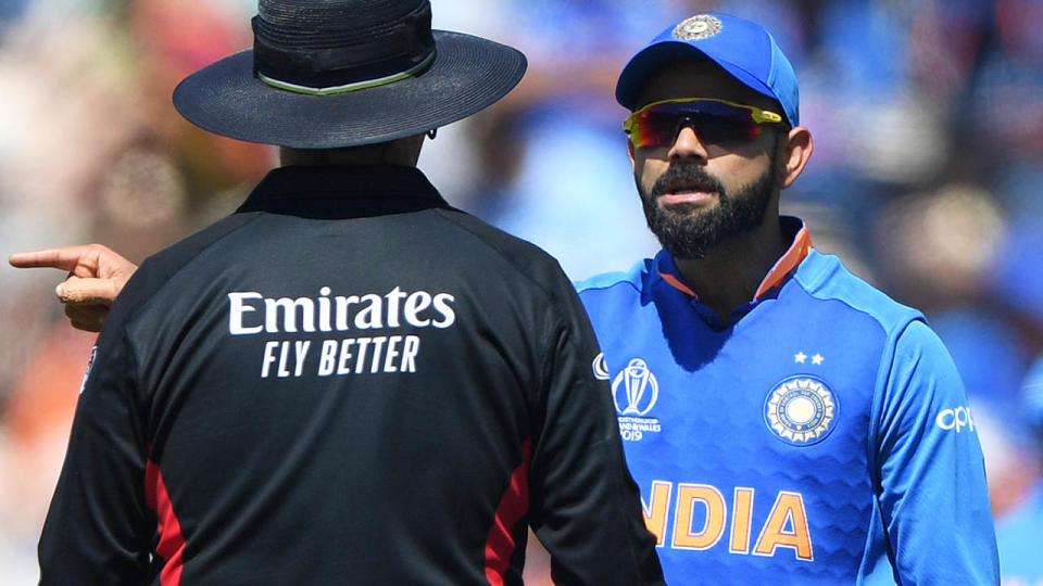 Virat Kohli speaks to umpire Richard Illingworth. (Photo by Stu Forster-IDI/IDI via Getty Images)