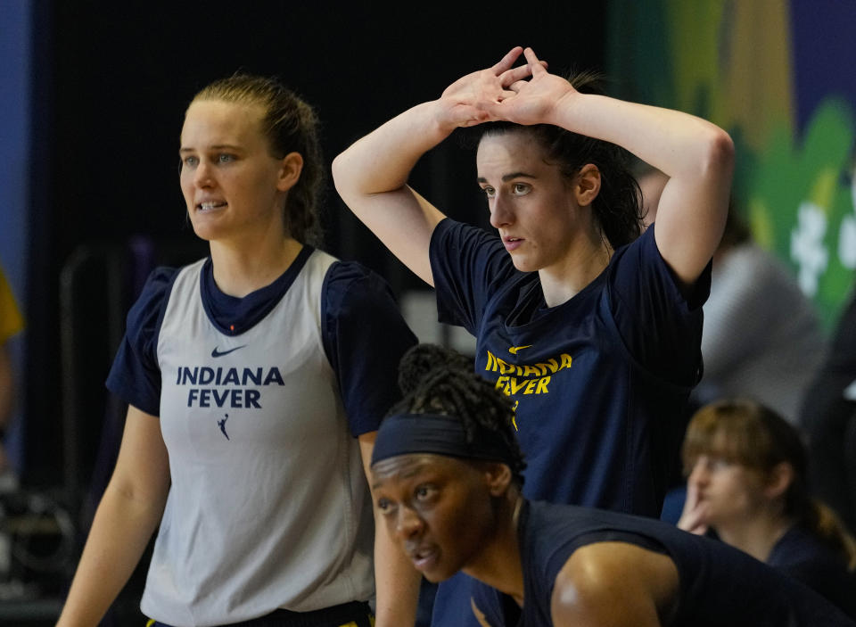 Indiana Fever guard Caitlin Clark, top right, watches from the sideline as the WNBA basketball team practices in Indianapolis, Sunday, April 28, 2024. (AP Photo/Michael Conroy)