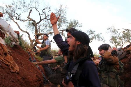 Rebel fighters cheer after what they said was an operation in which they blew up a tunnel targeting a post controlled by forces loyal to Syria's President Bashar al-Assad, in Ariha town in Idlib province May 12, 2015. REUTERS/Ammar Abdullah