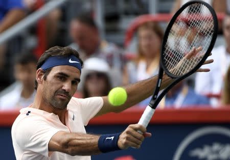 Aug 12, 2017; Montreal, Quebec, Canada; Roger Federer of Switzerland hits a backhand against Robin Haase of the Netherlands (not pictured) during the Rogers Cup tennis tournament at Uniprix Stadium. Mandatory Credit: Eric Bolte-USA TODAY Sports