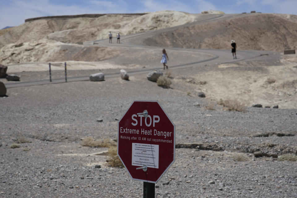 A sign warns of extreme heat danger Sunday, July 16, 2023, in Death Valley National Park, Calif. Death Valley's brutal temperatures come amid a blistering stretch of hot weather that has put roughly one-third of Americans under some type of heat advisory, watch or warning. (AP Photo/John Locher)