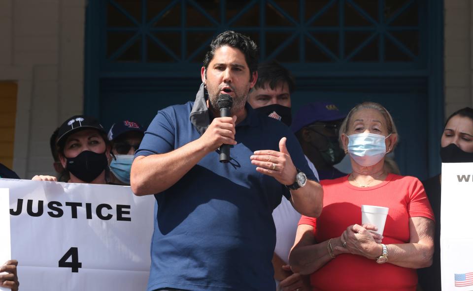 Fernando Martinez, center, was joined by his mother Mima Amaro, right, as he spoke during a rally in support of the Cuban community at the La Bodeguita restaurant in the NuLu district on Aug. 2, 2020.