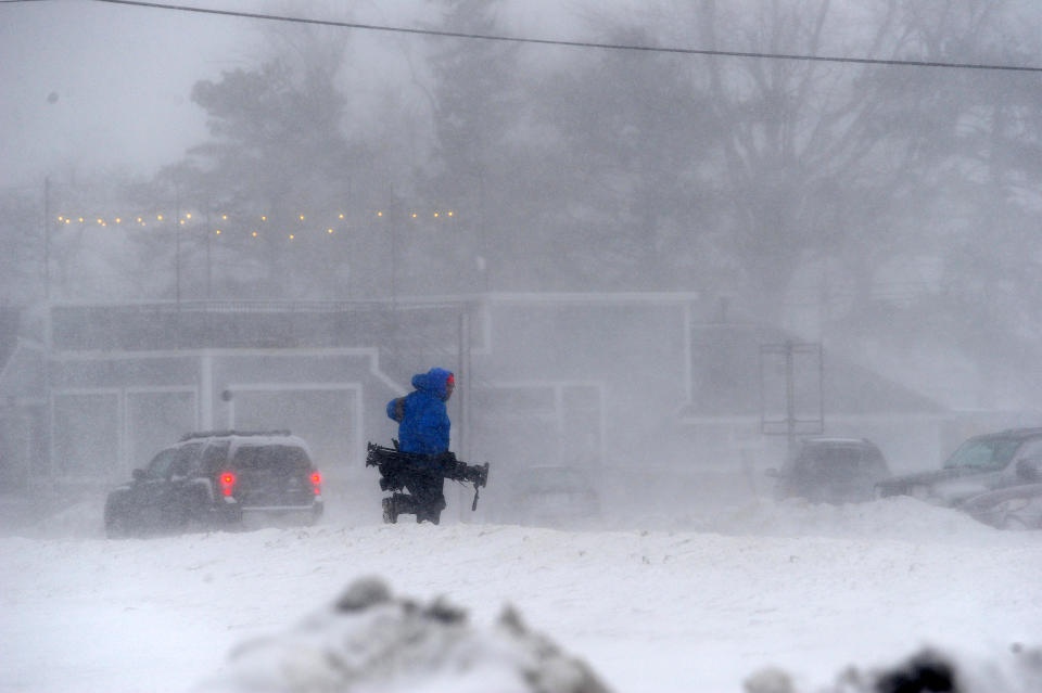 A member of the media battles snow and ice in Hamburg, N.Y., a Buffalo suburb