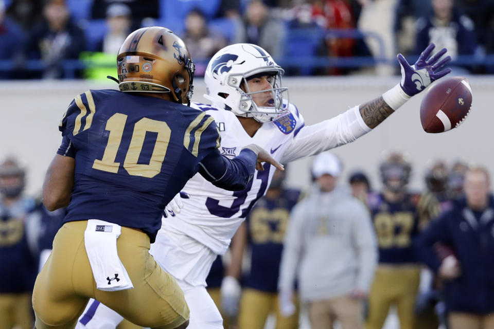 Kansas State defensive back Jahron McPherson (31) reaches for a pitchout from Navy quarterback Malcolm Perry (10) in the first half of the Liberty Bowl NCAA college football game Tuesday, Dec. 31, 2019, in Memphis, Tenn. (AP Photo/Mark Humphrey)