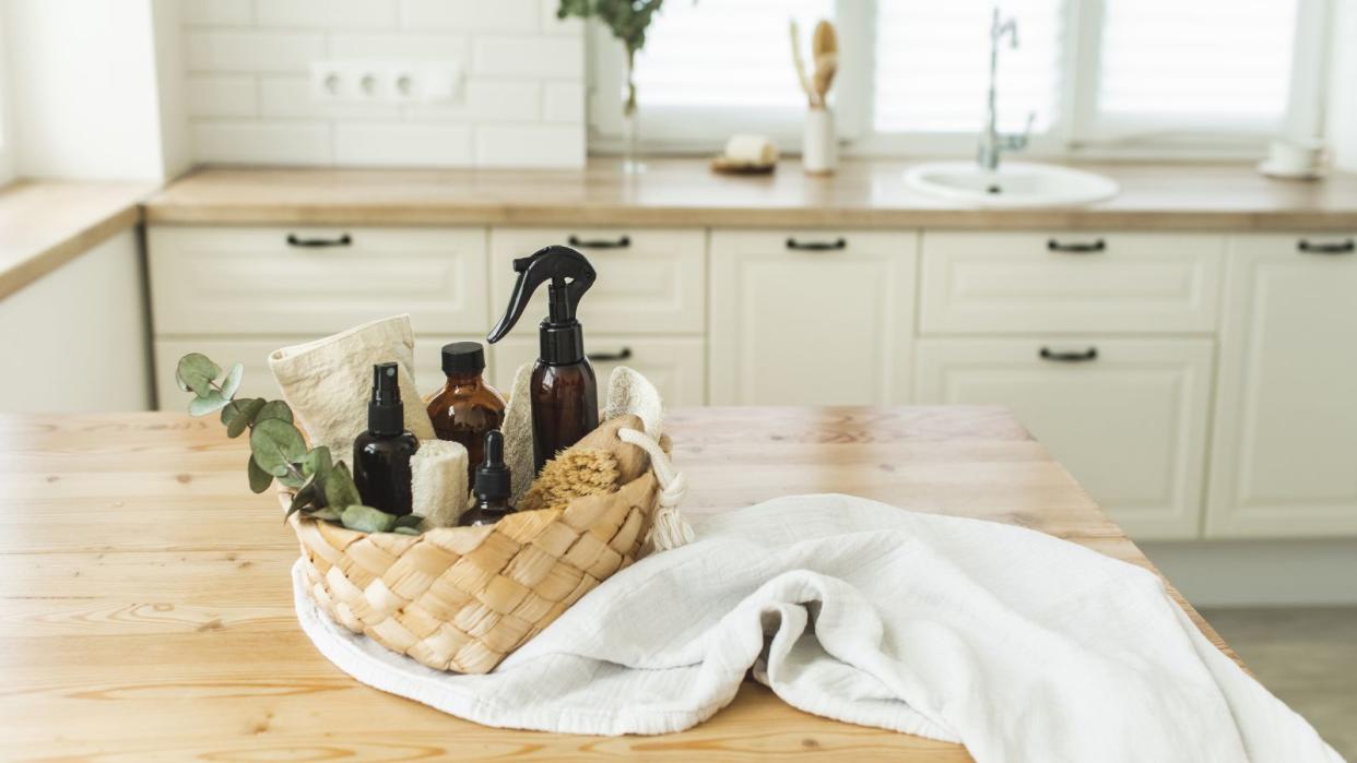  A set of natural cleaning supplies in a basket on a kitchen kitchen island 