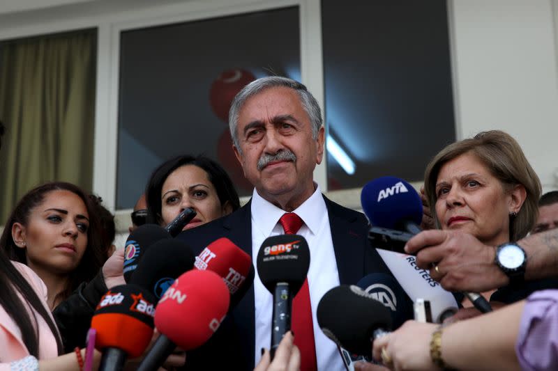 FILE PHOTO: Turkish Cypriot leadership candidate Mustafa Akinci speaks to media after voting at an elementary school in northern Nicosia