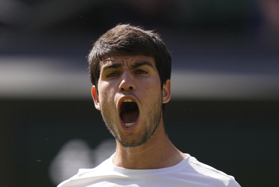 Spain's Carlos Alcaraz celebrates after beating Alexandre Muller of France in a men's singles match on day five of the Wimbledon tennis championships in London, Friday, July 7, 2023. (AP Photo/Alberto Pezzali)