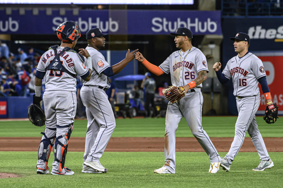 The Houston Astros celebrate after defeating the Toronto Blue Jays 11-7 in a baseball game Friday, April 29, 2022, in Toronto. (Christopher Katsarov/The Canadian Press via AP)