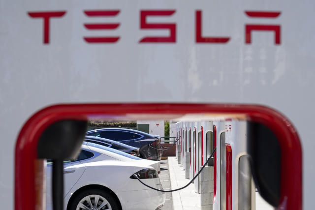 FILE - Tesla vehicles charge at a station in Emeryville, Calif., Aug. 10, 2022. Electric vehicles made by General Motors will be able to use much of Tesla&#39;s vast charging network starting early next year. GM joins Ford in shifting its vehicles to about 12,000 of Tesla&#39;s chargers, and both Detroit automakers are pushing to make Tesla&#39;s connector the industry standard. (AP Photo/Godofredo A. V&#xe1;squez, File)