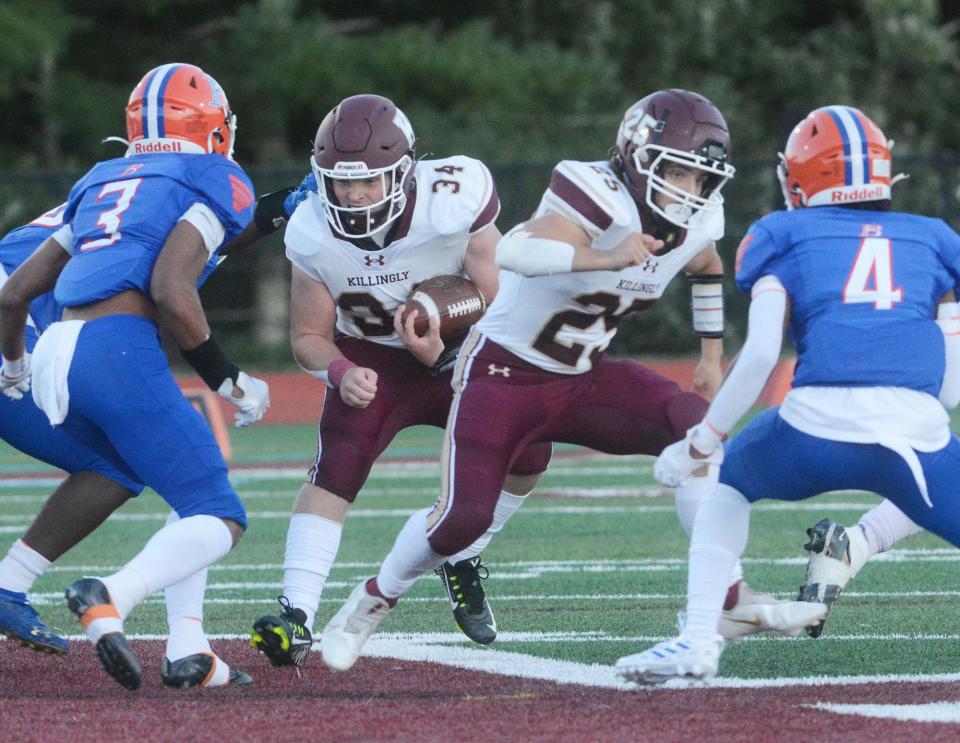 Killingly's Soren Rief gets a block from teammate Brady O'Donnell on Bloomfield's Jayden Johnson for a gain during Killingly's 28-22 win in Killingly.
(Photo: [John Shishmanian/ NorwichBulletin.com])