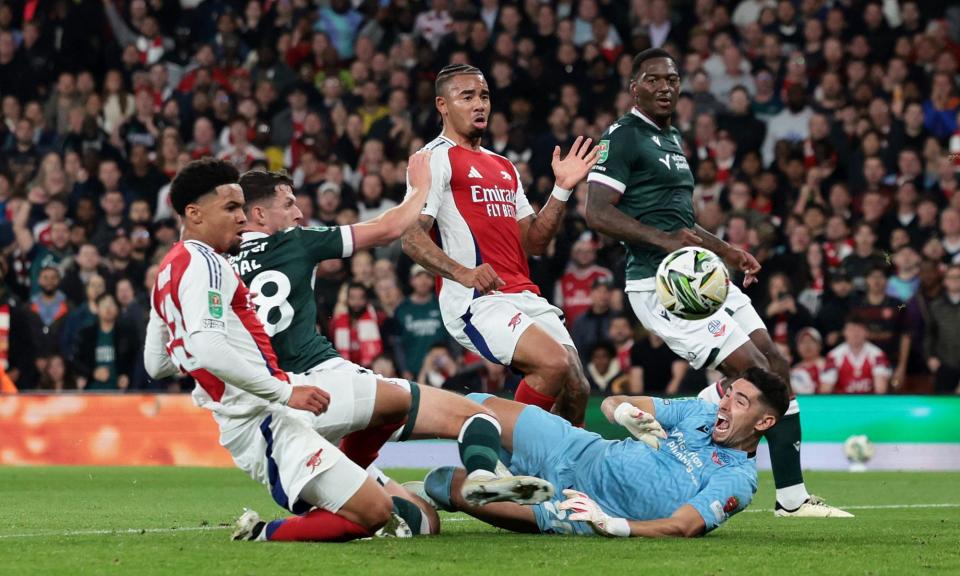 <span>Arsenal’s Ethan Nwaneri (left) slides in to score his side’s second goal.</span><span>Photograph: Paul Childs/Action Images/Reuters</span>