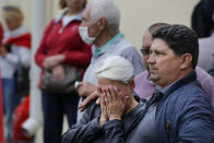 Friends and relatives of those detained during a mass rally following the presidential election, gather at a detention center in Minsk, Belarus, Wednesday, Aug. 12, 2020. Belarus officials say police detained over 1,000 people during the latest protests against the results of the country's presidential election. (AP Photo)