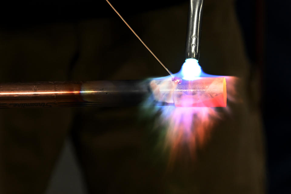 Boone Williams, 20, brazes a copper pipe during a second-year apprentice training program class at the Plumbers and Pipefitters Local Union 572 facility in Nashville, Tenn., on Thursday, Feb. 2, 2023. The union is working with young adults who graduated from high school during the pandemic and are taking career routes other than college for its apprentice program. (AP Photo/Mark Zaleski)