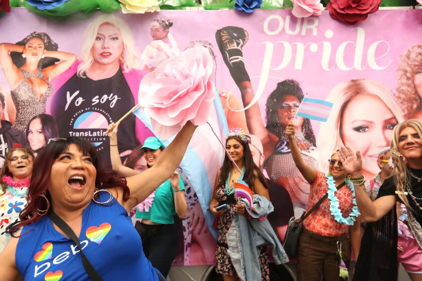 WEST HOLLWYOOD , CA - JUNE 4, 2023 - Alexa Lariy, in blue, joins members of the Trans Latina Coalition as they get into the spirit of the day at the WeHo Pride Parade in West Hollywood on June 4, 2023. (Genaro Molina / Los Angeles Times)