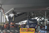 A crew inspects the damage to a part of a departure terminal canopy at New Delhi’s Indira Gandhi International Airport that collapsed in heavy pre-monsoon rains in New Delhi, India, Friday, June 28, 2024. (AP Photo)