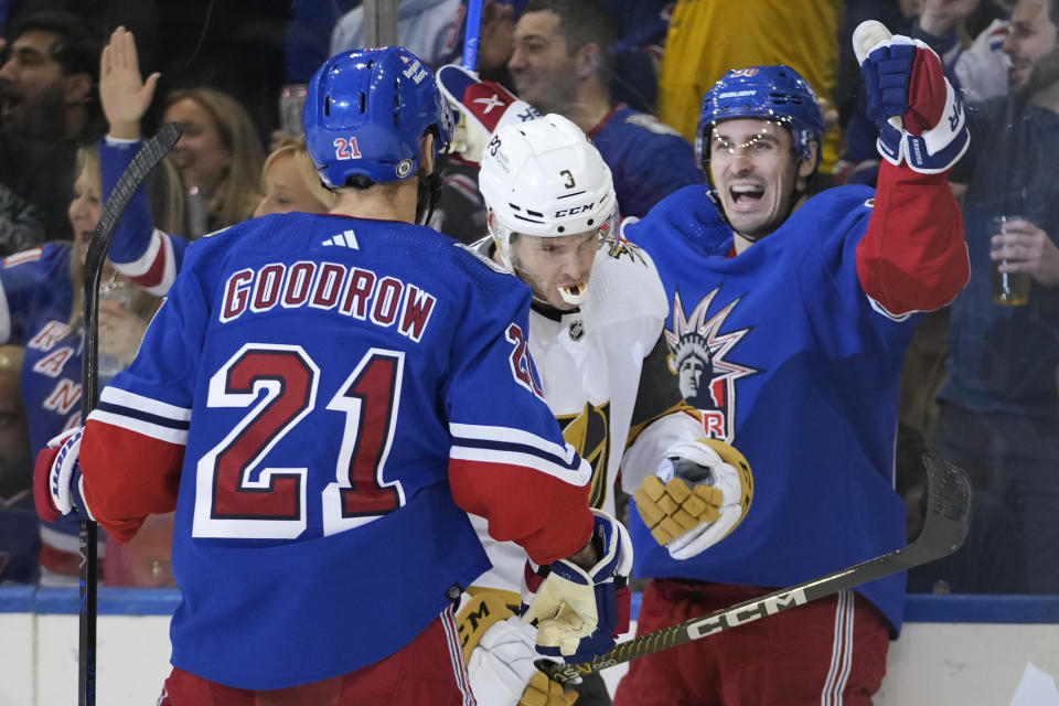 Vegas Golden Knights defenseman Brayden McNabb (3) skates between New York Rangers left wing Chris Kreider (20) and center Barclay Goodrow (21), who celebrate Kreider's goal during the first period of an NHL hockey game Friday, Jan. 27, 2023, at Madison Square Garden in New York. (AP Photo/Mary Altaffer)