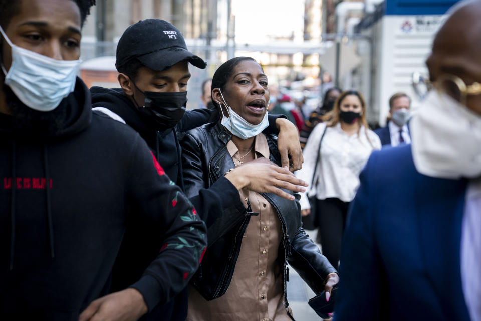 Family members of Andrew Abdullah, suspected of abruptly pulling a gun and killing a stranger on a New York City subway train, leave court and react with frustration towards members of the media, Wednesday, May 25, 2022, in New York. Abdullah was taken into custody on Tuesday, hours after authorities posted his name and photo on social media and implored the public to help find him. (AP Photo/John Minchillo)