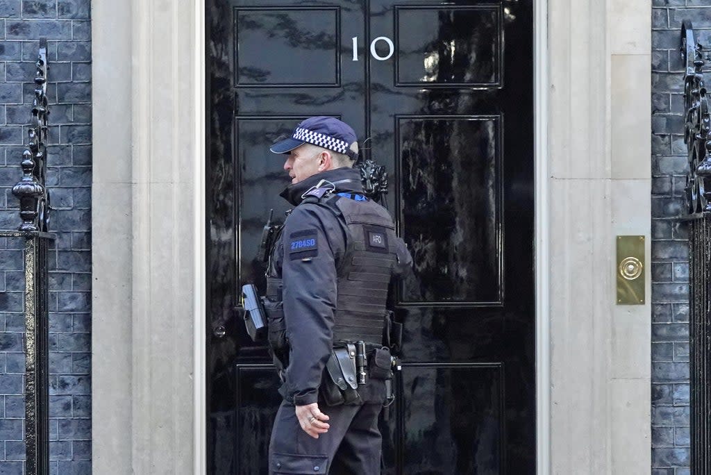 A police officer knocks on the door of the Prime Minister’s official residence in Downing Street, Westminster, London, as public anger continues following the leak on Monday of an email from Boris Johnson’s principal private secretary, Martin Reynolds, inviting 100 Downing Street staff to a “bring your own booze” party in the garden behind No 10 during England’s first lockdown on May 20, 2020. Picture date: Wednesday January 12, 2022. (Stefan Rousseau/PA) (PA Wire)