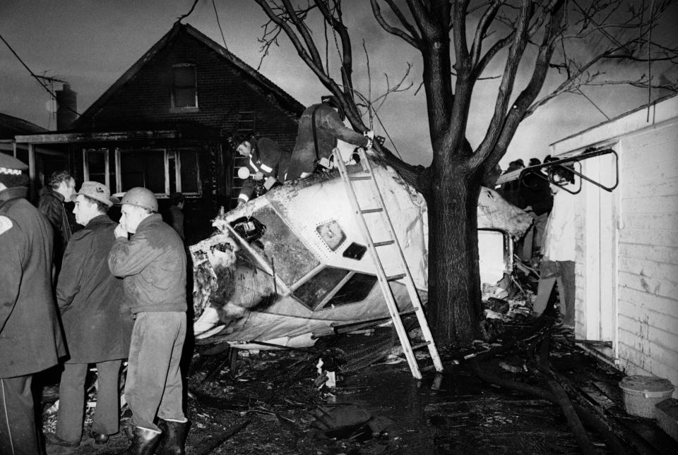 This is a view of pilot quarters in the crashed United Air Lines plane that shows it to have been split apart by force of the collision with brick and frame dwellings, Dec. 8, 1972, in Chicago. After striking homes on two sides of the street, it burned. Many of the more than 50 passengers perished. (AP Photo/Charles Knoblock)