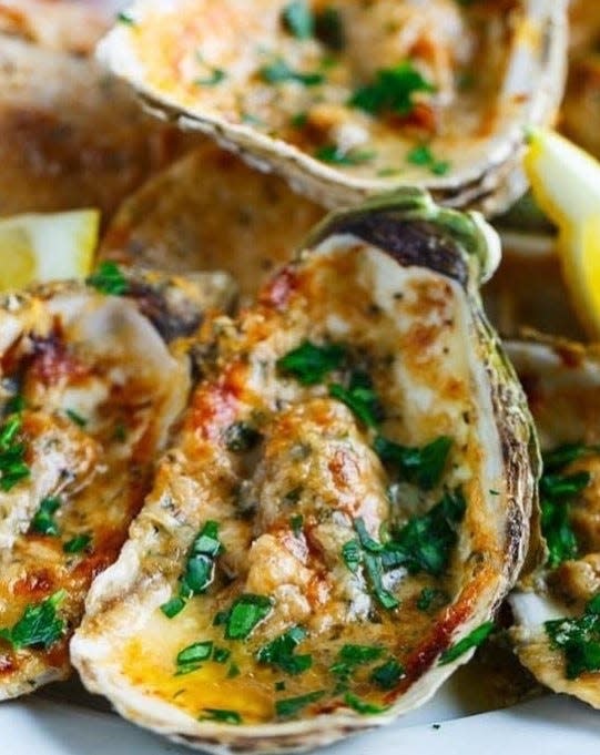 BRIA's char-grilled oysters sit in their shells surrounded with herb butter and topped with a blend of cheeses.