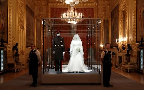 The wedding outfits of Meghan, Duchess of Sussex and Harry, Duke of Sussex have gone on display at Windsor Castle - Credit: Peter Nicholls/Reuters