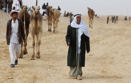 Sheikh Suleiman Abu Shukri walks during the opening of the International Camel Racing festival at the Sarabium desert in Ismailia, Egypt, March 21, 2017. Picture taken March 21, 2017. REUTERS/Amr Abdallah Dalsh
