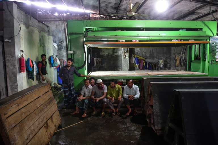 Bangladeshi workers rest at a tannery in Dhaka