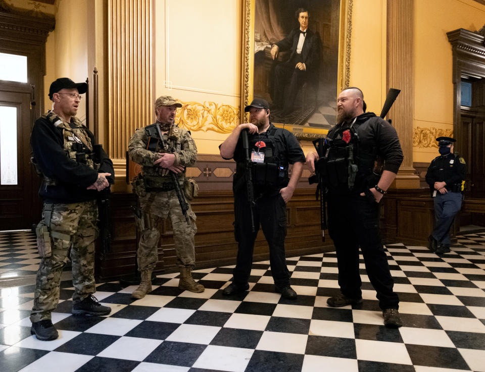 Armed members of a militia group gather at Michigan's Capitol building in April ahead of a vote on the extension of Gov. Gretchen Whitmer's emergency declaration/stay-at-home order due to the coronavirus. (Photo: Seth Herald / Reuters)