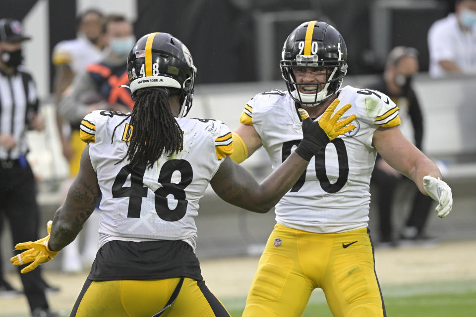 Pittsburgh Steelers linebacker Bud Dupree (48) and linebacker T.J. Watt, right, celebrate a big play against the Jacksonville Jaguars during the second half of an NFL football game, Sunday, Nov. 22, 2020, in Jacksonville, Fla. (AP Photo/Phelan M. Ebenhack)