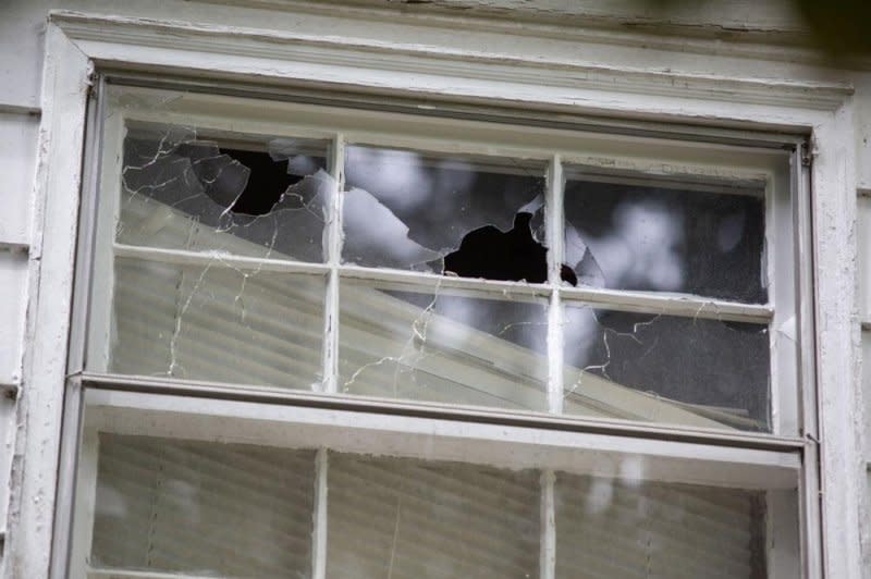 A second-story window shows bullet holes where police said Terry Clark Hughes Jr. opened fire on officers serving two arrest warrants at a home in Charlotte, N.C., Monday afternoon. Photo by Veasey Conway/EPA-EFE