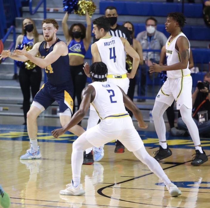 Delaware&#39;s Gianmarco Arletti (4), Ryan Allen, (2) and Kevin Anderson work on defense as La Salle&#39;s Christian Ray moves the ball in the second half of the Blue Hens&#39; 85-82 overtime win at the Bob Carpenter Center Wednesday, Nov. 17, 2021.