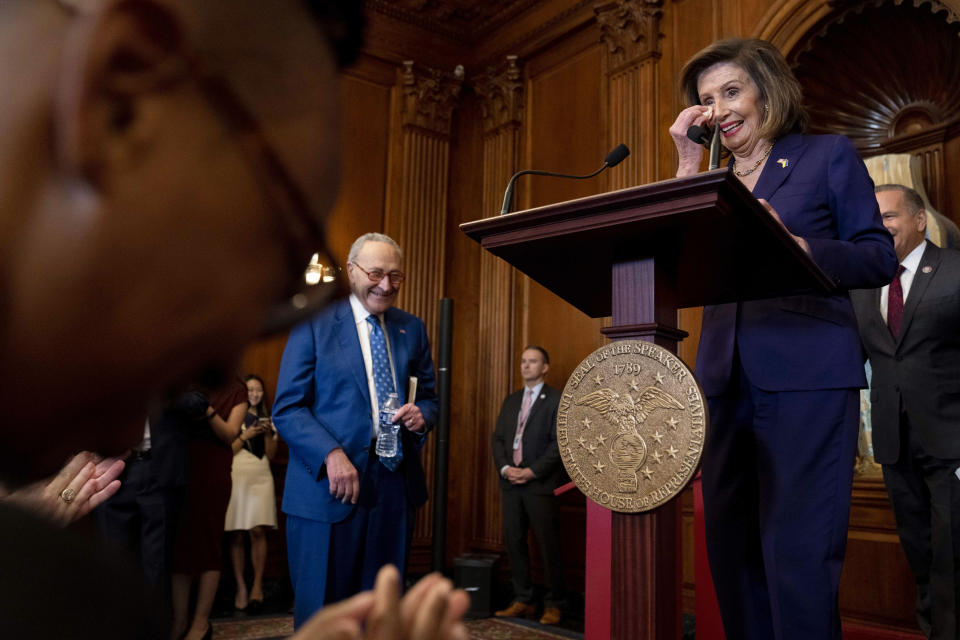 House Speaker Nancy Pelosi of Calif., right, accompanied by Senate Majority Leader Chuck Schumer of N.Y., left, wipes her eyes as she speaks before signing H.R. 8404, the Respect For Marriage Act, during a signing ceremony on Capitol Hill in Washington, Thursday, Dec. 8, 2022. (AP Photo/Andrew Harnik)