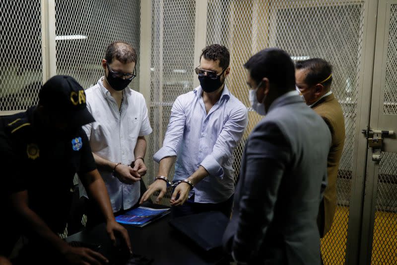 Ricardo (2nd L) and Luis Enrique, sons of former Panamanian President Ricardo Martinelli, are seen with their lawyers and a police officer after being detained to face extradition to the U.S. on money laundering charges, in Guatemala City