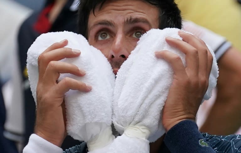 Heat is on: Novak Djokovic takes a break as temperatures hit the 35-degree mark in the first week