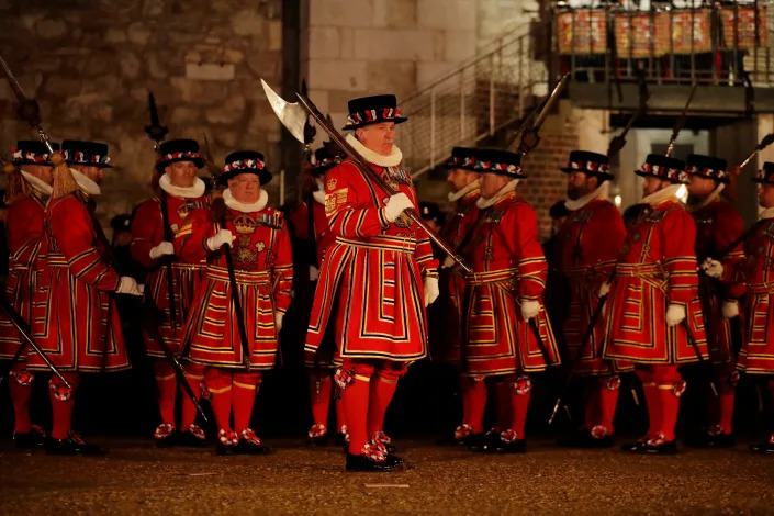 Yeoman Warders of the Tower of London, nicknamed Beefeaters, including the Chief Yeoman Warder Alan Kingshott, third right, carrying the Silver Mace, take part in a ceremony to install General Sir Nicholas Houghton as the 160th Constable of the Tower of London in London, Wednesday, Oct. 5, 2016.