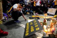 Mourners gather in Microsoft Square near the Staples Center to pay respects to Kobe Bryant after a helicopter crash killed the retired basketball star, in Los Angeles