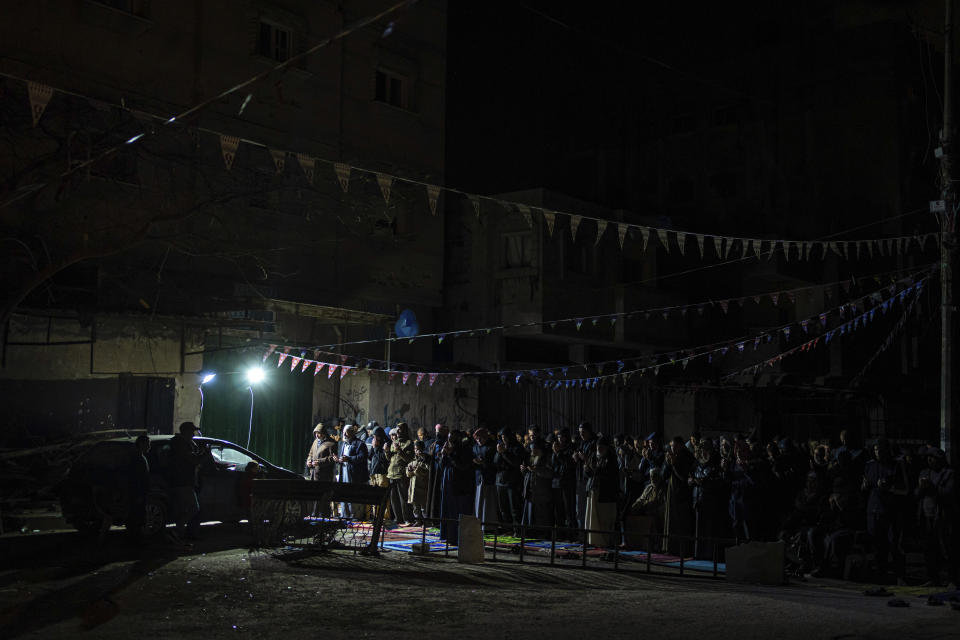 Muslim worshippers perform "tarawih," an extra lengthy prayer held during the Muslim holy month of Ramadan, in Rafah, Gaza Strip, Sunday, March 10, 2024. Officials in Saudi Arabia have declared the start of the fasting month of Ramadan after sighting the crescent moon Sunday night. The announcement marks the beginning of Ramadan for many of the world's 1.8 billion Muslims. (AP Photo/Fatima Shbair)