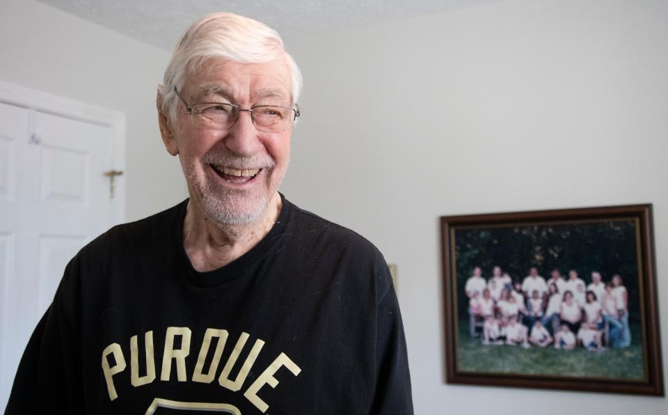 Bill Elbert smiles while showing the photos hanging in his office, Tuesday, March 26, 2024, at his home in West Lafayette, Ind.