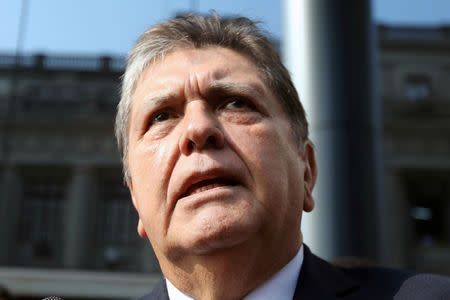 FILE PHOTO: Former Peruvian president Alan Garcia talks to the media as he arrives at the National Prosecution office in Lima, Peru March 27, 2018. REUTERS/Guadalupe Pardo/File Photo