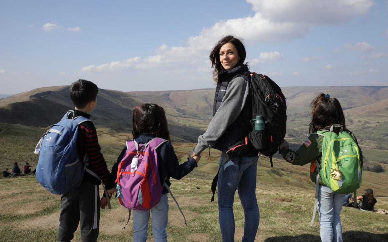 Julia Bradbury with her children walking at Mam Tor in the Peak District